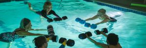 Senior participants enjoying a water aerobics class at Legacy Fitness, improving strength and flexibility.